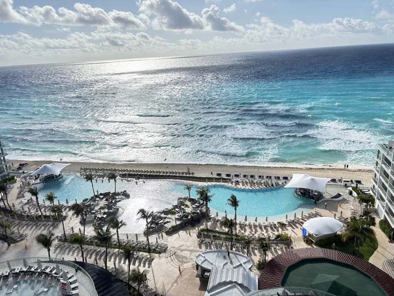 Infinity pools and the turquoise Caribbean seen from above at Hard Rock Cancún