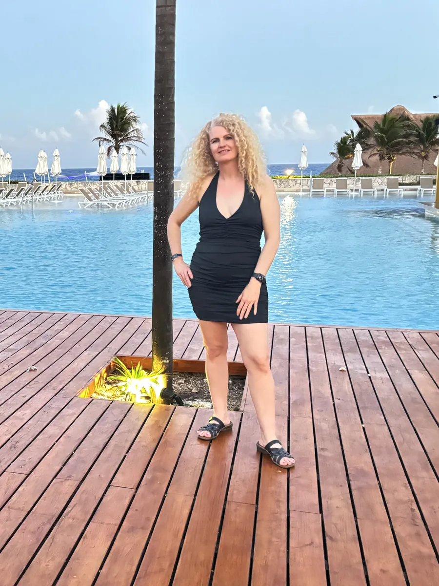Suzanne by the infinity pool at Hard Rock Riviera Maya at dusk