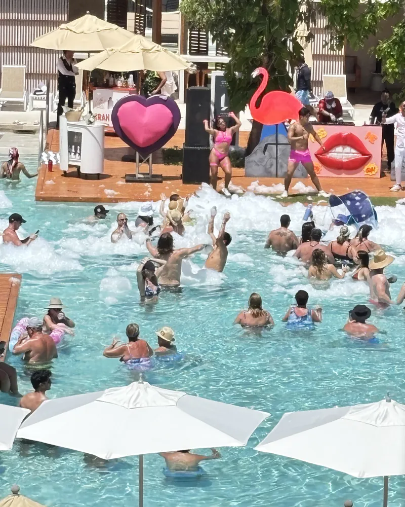 Foam pool party with pink flamingos and giant hearts at Hard Rock Riviera Maya